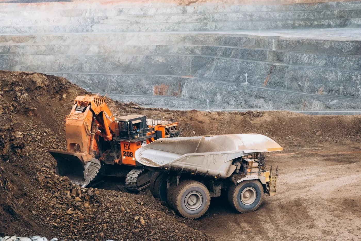 Excavator loading a haul truck in the pit